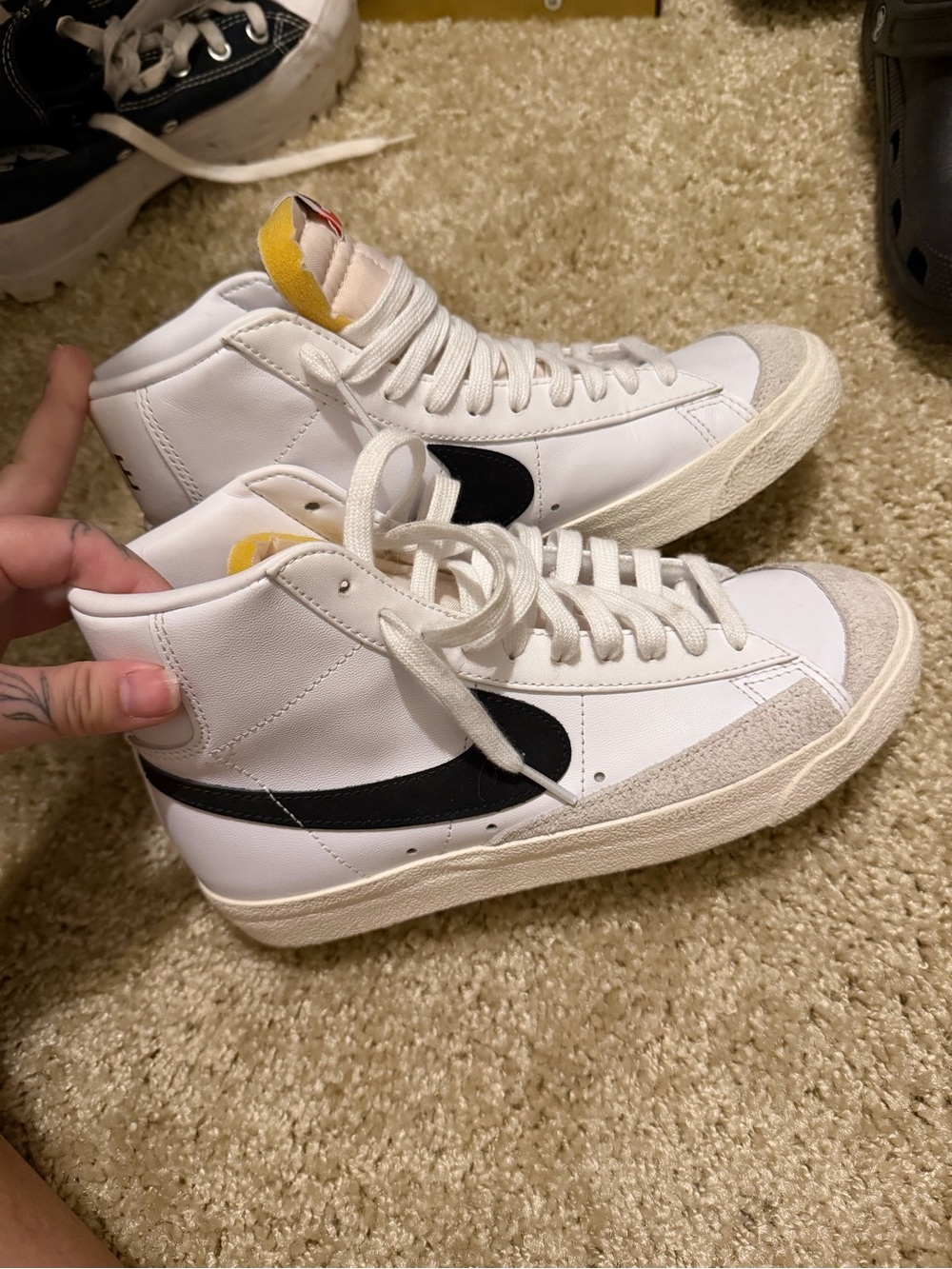Nike White High-Top Sneakers with Black Swoosh and Yellow Tongue